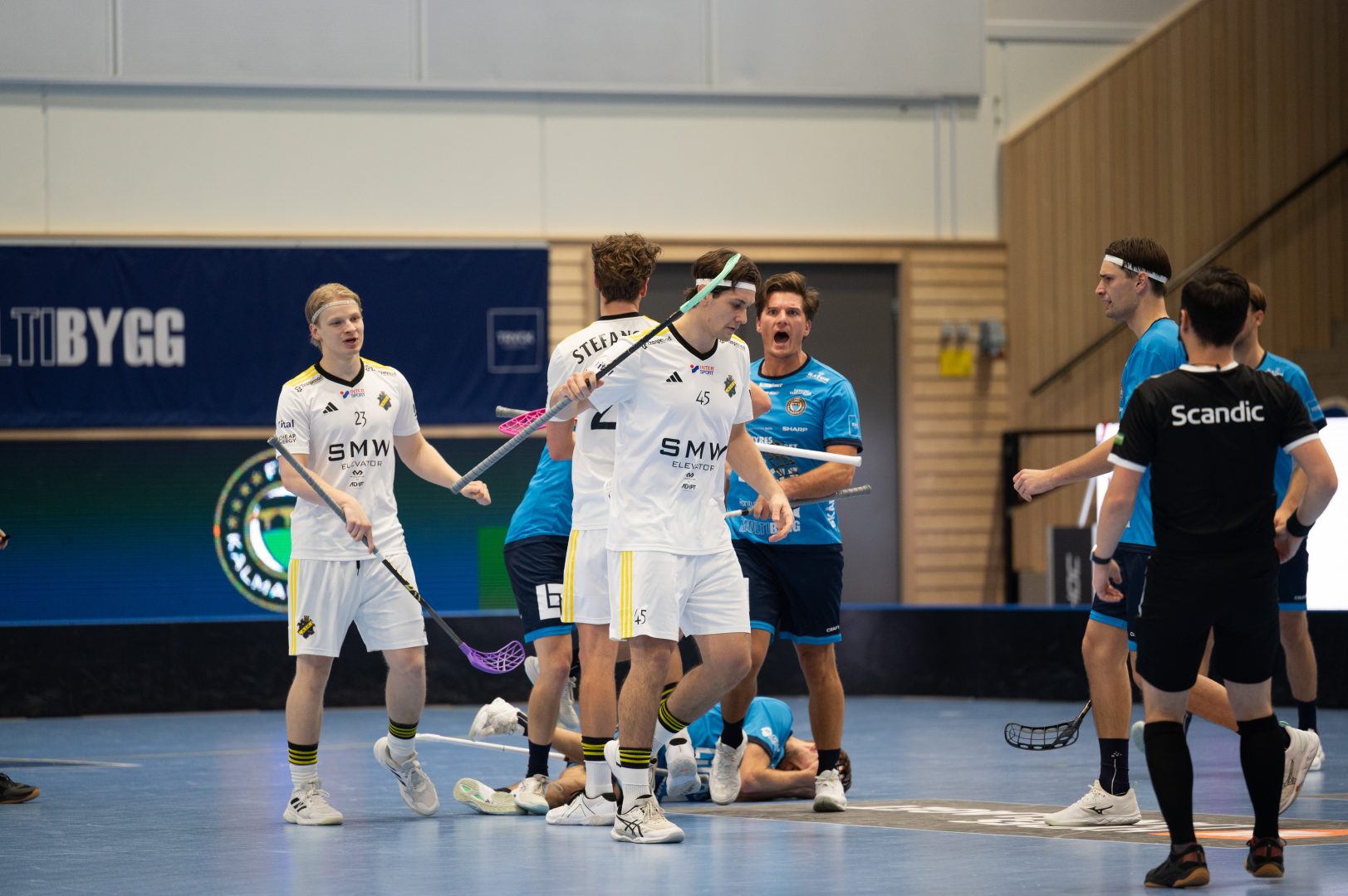 En kalmarsundspelare ligger på marken omringad av båda Kalmarsund och AIK spelare